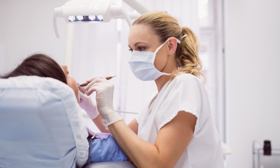 Eine Zahnärztin behandelt eine Patientin: Zahnzusatzpolicen sind die beliebtesten unter den Krankenzusatzversicherungen.